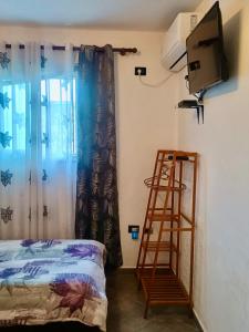 a room with a ladder and a television and a bed at Fati Guest House in Durrës