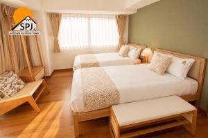 a hotel room with two beds and a window at Landmark Sunshine Hotel in Osaka