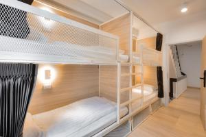 a room with two bunk beds and a staircase at The Ostel Hostel Bangkok in Bangkok +53 photos