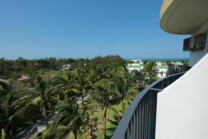 a view from the balcony of a resort with palm trees at Mona Luxe Apartment Hoi An in Hà My Tây (2)