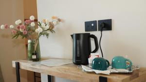 a table with a coffee maker and a vase of flowers at Casa Panerole in Novello