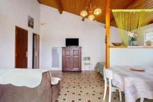 a bedroom with a bed and a table and a tv at Studio à La Ferme in Sémussac