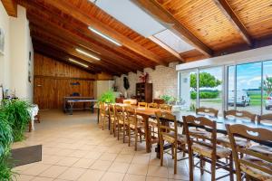 a large dining room with a table and chairs at Studio à La Ferme in Sémussac