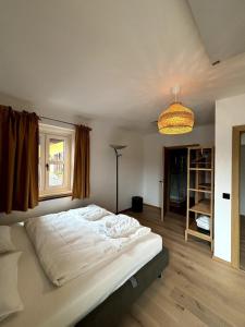 a bedroom with a bed and a lamp and a window at Chic & Cozy Lake View Apartment in Seeboden +3 photos