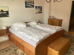 a bedroom with a large bed with a wooden frame at Schlossblick Apartment in Gotha