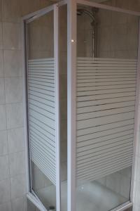 a shower with a glass door in a bathroom at Hotel Alt-Lennep in Remscheid +24 photos