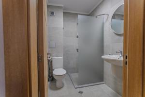 a bathroom with a toilet and a sink at Family Hotel Deja Vu in Ravda +39 photos