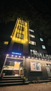 a tall building with lights on it at night at Hotel Crystal Inn in Lucknow