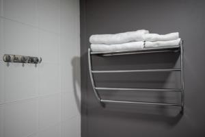 a towel rack in a bathroom with white towels at โรงแรมต้นเงิน in Khon Kaen +52 photos