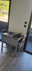 a table and a chair in a room with a window at Studio Mountain Star Dream in Sainte-Marie-de-Cuines