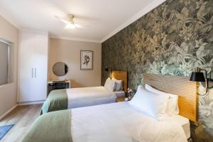 a hotel room with two beds and a wall mural at Wartburg Guesthouse in Wartburg +24 photos