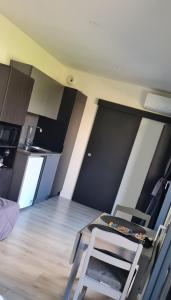 a kitchen with a table and a chair in a room at Studio Mountain Star Dream in Sainte-Marie-de-Cuines