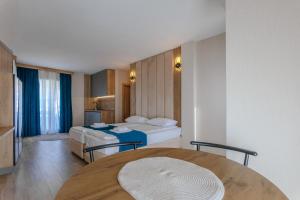 a hotel room with a bed and a table at Family Hotel Deja Vu in Ravda