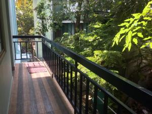 a balcony with a black railing and trees at Cherish homestay in Cochin