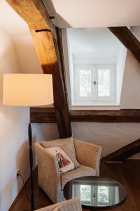 a room with a table and a chair and a window at Schloss Maierhofen in Painten