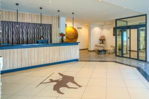 a shadow of a dog on the floor of a lobby at Hotel Alkar - Family Friendly Hotel with Pool in Sinj, Dalmatia in Sinj +115 photos