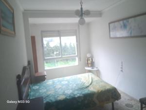 a bedroom with a bed and a window at Mountain View Village Life in Bárig
