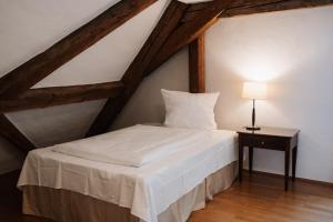 a bedroom with a bed and a table with a lamp at Schloss Maierhofen in Painten +96 photos