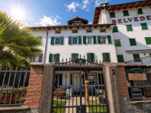 a building with a fence in front of it at Casa Zarabara in Arta Terme