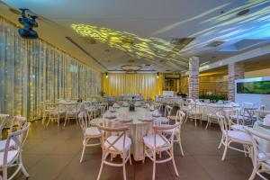 a banquet hall with white tables and chairs at Hotel Alkar - Family Friendly Hotel with Pool in Sinj, Dalmatia in Sinj