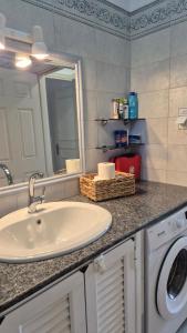 a bathroom with a sink and a washing machine at Villa Anna in Skaliá +70 photos
