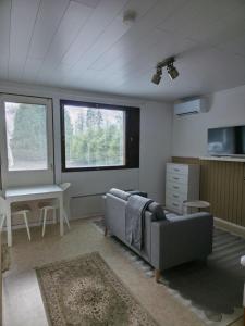 a living room with a couch and a table at Kotoisa 1 in Seinäjoki