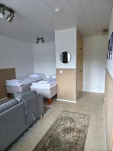 a living room with a couch and a room with beds at Kotoisa 1 in Seinäjoki