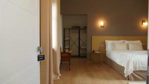 a bedroom with a large white bed and a chair at Casa Panerole in Novello