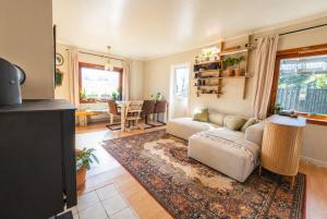 a living room with a couch and a table at Alfa Room - The LOWFO House Lofoten in Moskenes