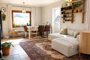 a living room with a couch and a table at Alfa Room - The LOWFO House Lofoten in Moskenes