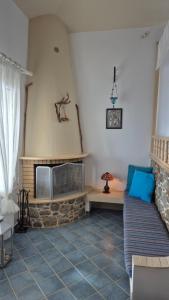 a living room with a couch and a fireplace at Villa Anna in Skaliá