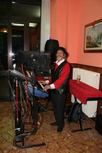 a man is standing in front of a keyboard at Albergo Sala in Valbrona