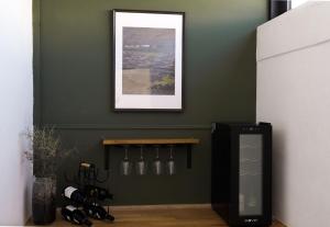 a kitchen with a green wall with a refrigerator at Casa Aulaga in Yaiza