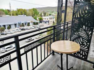 a table on a balcony with a view of a city at Central Park Hotel 中央公园酒店 in Jalal-Abad