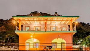 a building with a table in front of it at Aasara Homestay Bhimtal Orchard Villa in Bhīm Tāl
