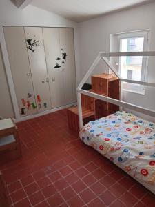 a bedroom with a bunk bed and a desk at 3 la Placette in Varages