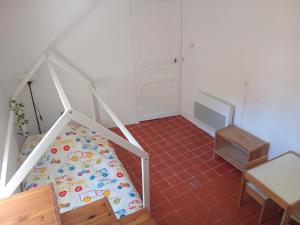 a bedroom with a bed and a tiled floor at 3 la Placette in Varages