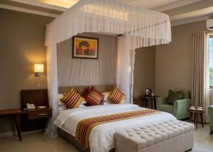 a bedroom with a large bed with a canopy at Rosewood by Amaryllis Lilongwe in Lilongwe