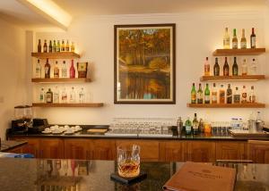 a bar with a bunch of bottles on the wall at Rosewood by Amaryllis Lilongwe in Lilongwe