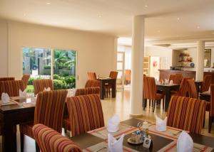 a dining room with tables and chairs at Rosewood by Amaryllis Lilongwe in Lilongwe