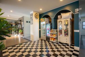 a store with two refrigerators on a checkered floor at โรงแรมต้นเงิน in Khon Kaen