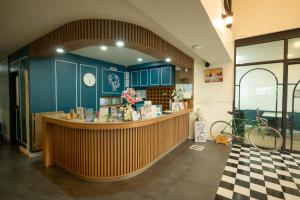 a restaurant with blue cabinets and a counter at โรงแรมต้นเงิน in Khon Kaen