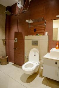 a bathroom with a toilet and a sink at Gems Munnar in Anachal +9 photos
