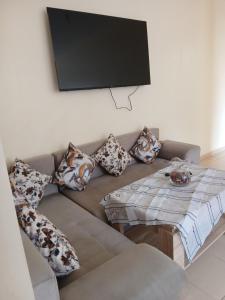 a living room with a couch with pillows and a table at Irini in Ifrane