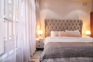 a bedroom with a bed with a large window at Bustani Home Studio in Arusha