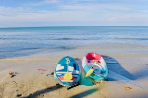 two surfboards sitting on the sand on the beach at Kacha Resort & Spa, Koh Chang in Ko Chang