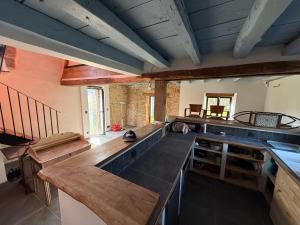a kitchen with wooden counters and a counter top at 9 La Roche La Bergerie in Saint-Plantaire