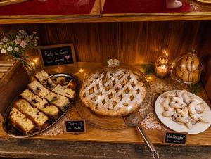 a table with a pie and other desserts on it at Casa Zarabara in Arta Terme +17 photos