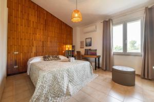 a bedroom with a bed and a wooden wall at Luxi noa in Quartu SantʼElena