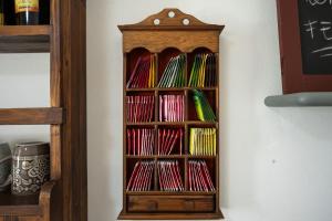 a wooden book shelf with many colored books at Luxi noa in Quartu SantʼElena